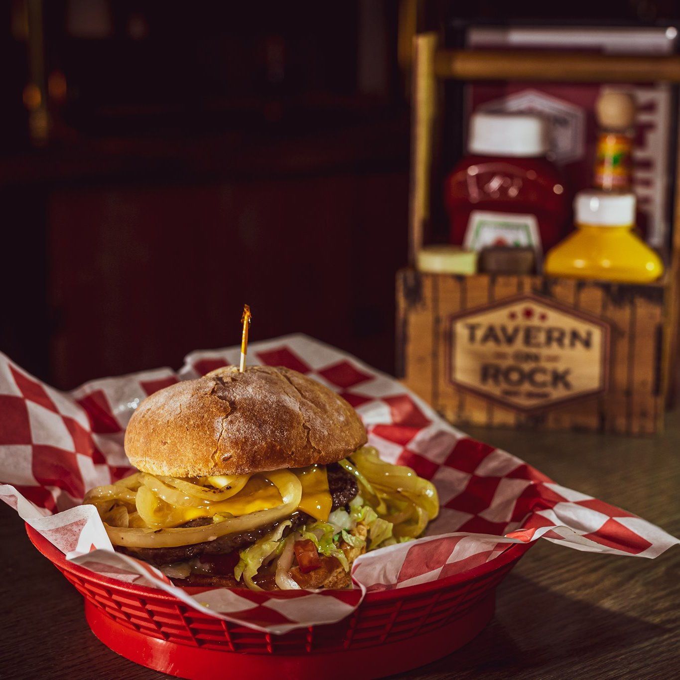 Cheeseburger with grilled onions in a Tavern on Rock basket