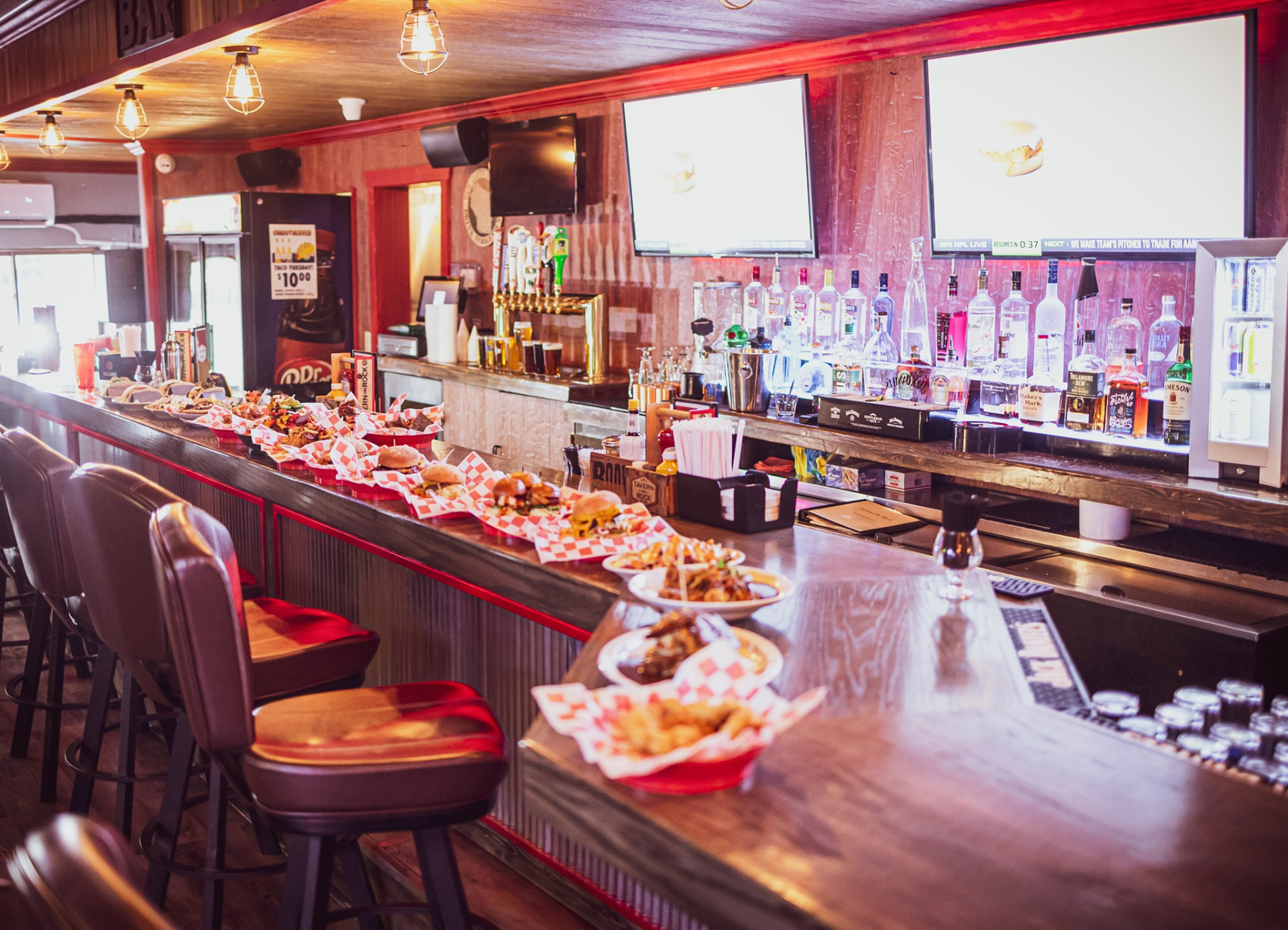 Baskets of burgers and appetizers lined up along the bar at Tavern on Rock