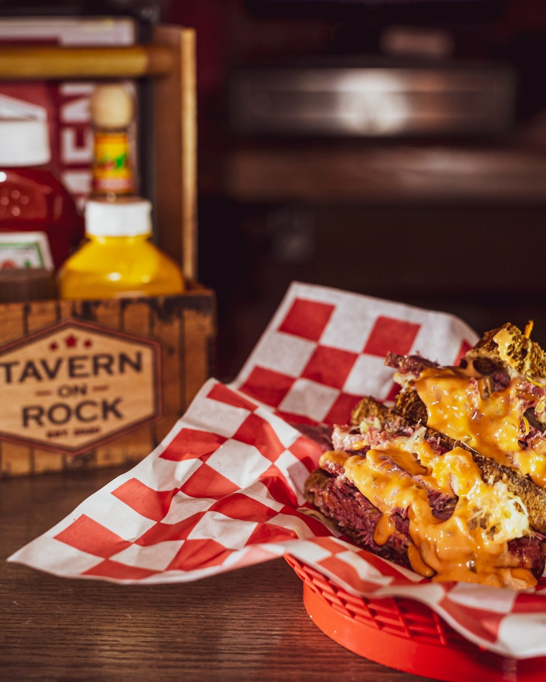 Stacked Reuben sandwich in a red Tavern on Rock basket
